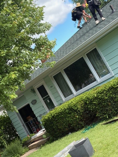 Before photo of light green home roofline and gutters before fascia replacement